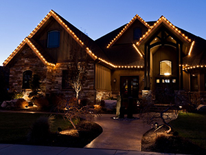 Clear lights decorate the gutters and gables of this property.