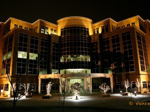 A large office building outlined in Christmas lights.