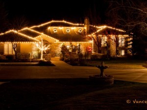 The rooftop of this home is decorated with Christmas lights.