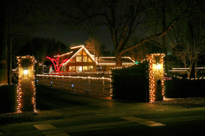 Mini lights decorate the fence around this home.